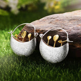 Silver Moon Bowl Earrings with Golden Leaf Sprout Design