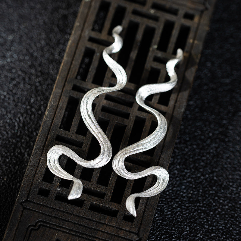 Wavy Silver Drop Earrings with Abstract Snake Energy