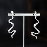 Wavy Silver Drop Earrings with Abstract Snake Energy