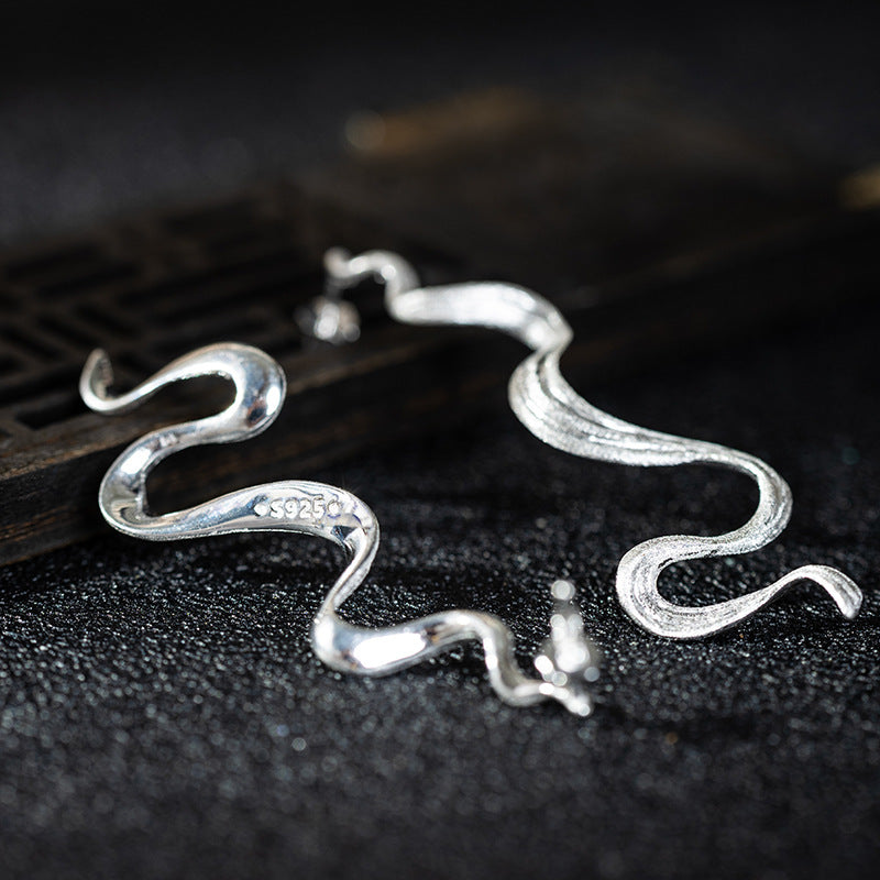 Wavy Silver Drop Earrings with Abstract Snake Energy